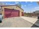Garage featuring an oversized garage door and an additional storage room at 6860 Krameria St, Commerce City, CO 80022