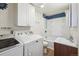 Functional laundry room with washer, dryer, and adjacent bathroom with convenient storage and shower at 6860 Krameria St, Commerce City, CO 80022