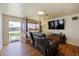 Inviting living room with hardwood floors, large TV, and comfortable seating area, perfect for relaxation at 6860 Krameria St, Commerce City, CO 80022