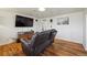 Inviting living space with hardwood floors, a modern entertainment center, and comfortable furnishings at 6860 Krameria St, Commerce City, CO 80022