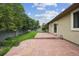 Backyard boasts a stone patio, grassy lawn, and mature trees, perfect for outdoor entertaining at 1235 S Balsam St, Lakewood, CO 80232