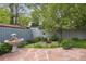 Backyard featuring a stone patio and lush landscaping, creating a peaceful outdoor retreat at 1235 S Balsam St, Lakewood, CO 80232