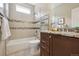 Modern bathroom features granite countertop, beautiful tile backsplash, and a shower-tub combo at 1235 S Balsam St, Lakewood, CO 80232