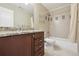 Nicely appointed bathroom with granite counters, shower-tub, and modern fixtures at 1235 S Balsam St, Lakewood, CO 80232