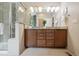 Bathroom featuring a glass shower, granite countertops, and stylish cabinets with double sinks at 1235 S Balsam St, Lakewood, CO 80232