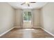 Empty bedroom featuring wood floors, neutral walls, a ceiling fan, and a window with natural light at 1235 S Balsam St, Lakewood, CO 80232