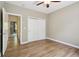 Empty bedroom featuring wood floors, neutral walls, a ceiling fan, and a closet with sliding doors at 1235 S Balsam St, Lakewood, CO 80232
