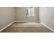 Carpeted bedroom with neutral walls and natural light from a large window at 1235 S Balsam St, Lakewood, CO 80232