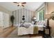 Bright bedroom showcasing a vaulted ceiling, statement wallpaper, and a large window with views of the outdoors at 1235 S Balsam St, Lakewood, CO 80232