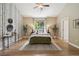 Well-lit bedroom with wood floors, neutral walls, and a large window creating a bright and inviting space at 1235 S Balsam St, Lakewood, CO 80232
