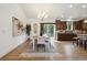 Elegant dining area adjacent to the kitchen with modern lighting and access to outdoor living space at 1235 S Balsam St, Lakewood, CO 80232