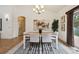 Bright dining room with a modern chandelier, stylish decor, and a large window overlooking the yard at 1235 S Balsam St, Lakewood, CO 80232
