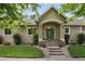 Charming home featuring a green front door, beautiful landscaping, and a welcoming entrance at 1235 S Balsam St, Lakewood, CO 80232