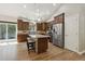 Open kitchen with stainless steel appliances, granite countertops, an island with seating and access to patio at 1235 S Balsam St, Lakewood, CO 80232