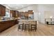 Modern kitchen with stainless steel appliances, granite countertops, and a stone-accented island with seating at 1235 S Balsam St, Lakewood, CO 80232