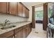 Well-equipped laundry room with granite countertops, custom cabinets and modern washer/dryer units at 1235 S Balsam St, Lakewood, CO 80232