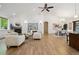 Expansive living room featuring vaulted ceilings, a fireplace, and open access to the dining area at 1235 S Balsam St, Lakewood, CO 80232