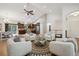 Open-concept living space with vaulted ceilings, abundant natural light, and seamless flow to kitchen at 1235 S Balsam St, Lakewood, CO 80232