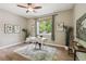 Home office featuring a desk, stylish decor, wood floors, a ceiling fan and ample natural light at 1235 S Balsam St, Lakewood, CO 80232