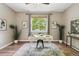 Home office featuring a modern desk, stylish decor, wood floors, and ample natural light at 1235 S Balsam St, Lakewood, CO 80232
