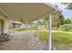 Relaxing covered back patio with stylish flooring and a ceiling fan overlooking the spacious backyard at 2996 S Sheridan Blvd, Denver, CO 80227