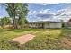 Expansive backyard featuring lush green grass and mature trees, offering a serene outdoor space at 2996 S Sheridan Blvd, Denver, CO 80227