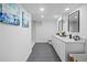 Bathroom with double sinks, modern lighting, and sleek tile flooring for a spa-like experience at 2996 S Sheridan Blvd, Denver, CO 80227