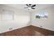 Inviting bedroom featuring hardwood floors, a ceiling fan, and a large window with outside views at 2996 S Sheridan Blvd, Denver, CO 80227