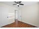 Comfortable bedroom with hardwood floors, white trim, a ceiling fan, and closet space for ample storage at 2996 S Sheridan Blvd, Denver, CO 80227