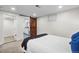 Bedroom with a rustic barn door and access to the bathroom creates a unique and stylish space at 2996 S Sheridan Blvd, Denver, CO 80227