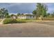 Exterior shot of a single-story home with a fenced yard and lush landscaping in a neighborhood setting at 2996 S Sheridan Blvd, Denver, CO 80227