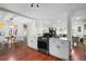 Bright kitchen with white cabinets, stainless steel appliances, and an open concept design flows into the living area at 2996 S Sheridan Blvd, Denver, CO 80227