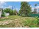 Large backyard featuring mature trees, a garden, and a storage shed at 1001 Victor St, Aurora, CO 80011