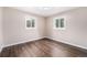 Inviting bedroom with hardwood floors, neutral walls, and two windows allowing for ample natural light at 1001 Victor St, Aurora, CO 80011