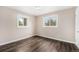 Comfortable bedroom boasts hardwood floors, neutral walls, and two windows that provide natural light at 1001 Victor St, Aurora, CO 80011