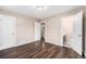 Spacious bedroom featuring hardwood floors and multiple access doors to the en-suite bathroom at 1001 Victor St, Aurora, CO 80011