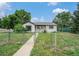 Charming single-story home featuring a well-maintained yard and a classic white exterior at 1001 Victor St, Aurora, CO 80011