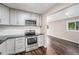 Modern kitchen with stainless steel appliances, updated cabinetry, and seamless flow into the living area at 1001 Victor St, Aurora, CO 80011