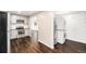 Kitchen features stainless steel appliances and transitions to a laundry area and adjoining rooms at 1001 Victor St, Aurora, CO 80011