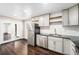 Stylish kitchen with stainless steel appliances, sleek cabinets, and access to a bright outdoor space at 1001 Victor St, Aurora, CO 80011