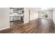 Open-concept kitchen with modern stainless steel appliances, light gray cabinets, and wood-look flooring at 1001 Victor St, Aurora, CO 80011