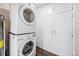 Modern laundry room with a stacked washer and dryer set and ample storage cabinets at 1001 Victor St, Aurora, CO 80011
