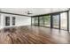 Large living area boasting hardwood floors, a ceiling fan, and sliding doors offering backyard views at 1001 Victor St, Aurora, CO 80011