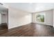 Bright living room with wood-look floors, a large window, and neutral walls for a modern feel at 1001 Victor St, Aurora, CO 80011