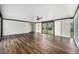 Expansive living room featuring hardwood floors, a ceiling fan, and sliding doors to the backyard at 1001 Victor St, Aurora, CO 80011