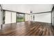 Bright sunroom with hardwood floors, fan, and lots of windows, perfect for enjoying indoor/outdoor living at 1001 Victor St, Aurora, CO 80011