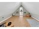 Spacious attic area with sloped ceilings, cork flooring, and open doorway, creating an airy, adaptable space at 1729 N Clarkson St, Denver, CO 80218