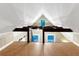 Bright attic space with exposed beams, wood flooring, and ample natural light from multiple windows at 1729 N Clarkson St, Denver, CO 80218