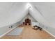 Inviting attic room featuring sloped ceilings, cork flooring, and vintage furnishings for a cozy ambiance at 1729 N Clarkson St, Denver, CO 80218