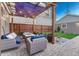 Inviting backyard patio with pergola, seating, fire pit, and manicured landscaping for outdoor enjoyment at 1729 N Clarkson St, Denver, CO 80218